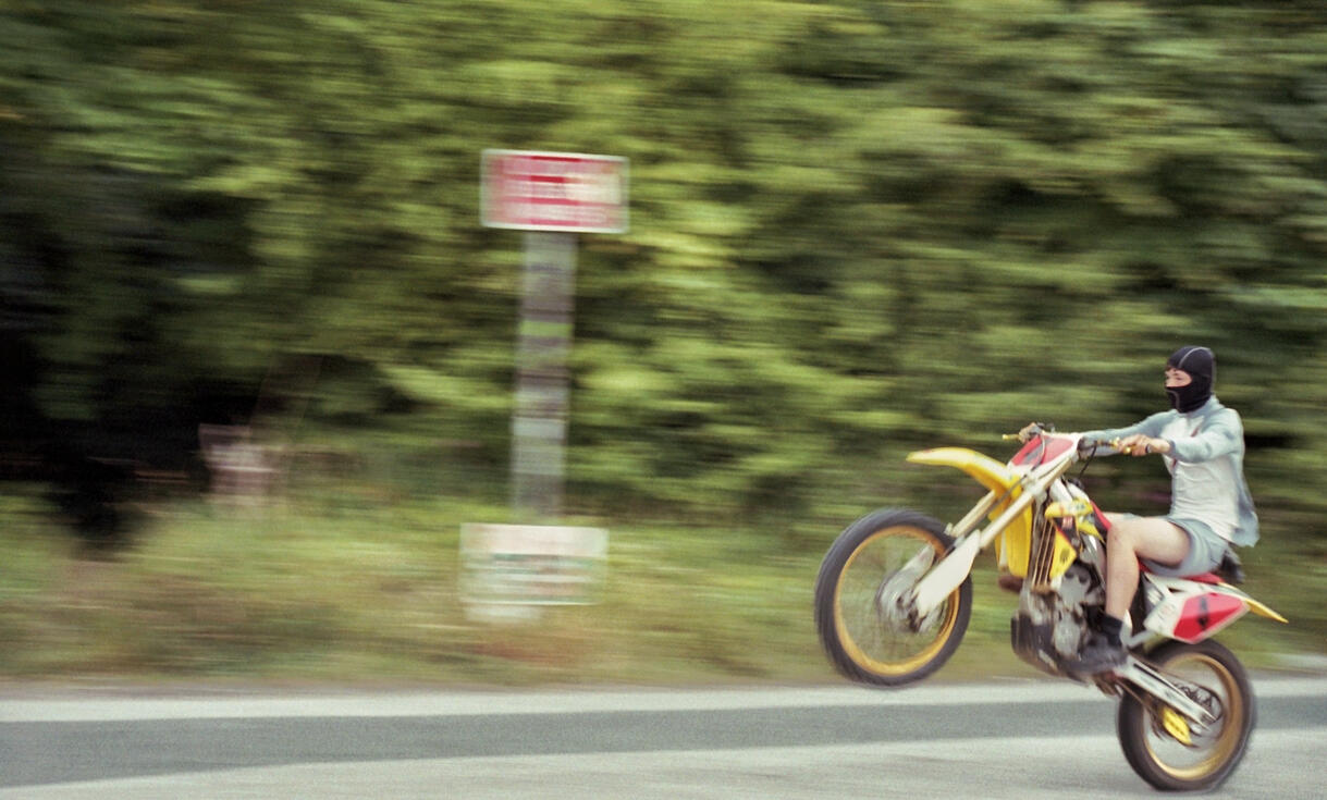 Motocross rider powering along a dirt track Motocross rider powering along a dirt track