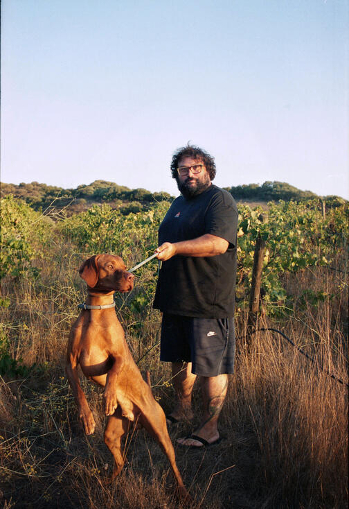 Gianluca with his dog at Colline Del Vento vineyard, Sardinia Gianluca with his dog at Colline Del Vento vineyard, Sardinia