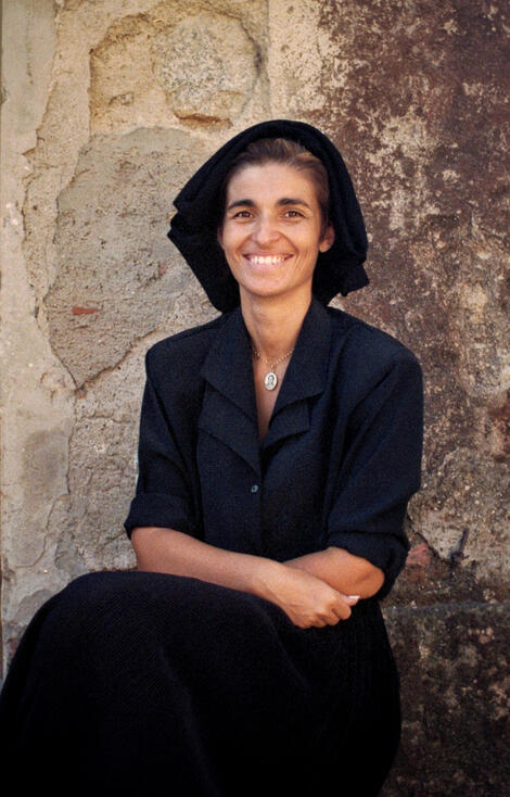 Woman in traditional Sardinian dress against an old wall Woman in traditional Sardinian dress against an old wall