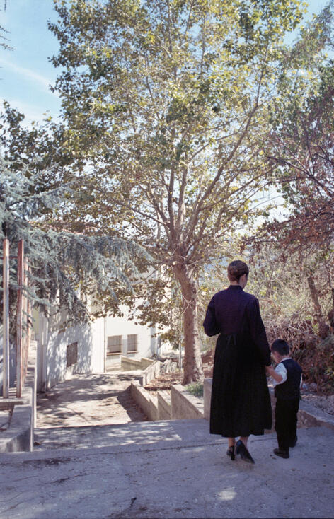 Priest walking toward a farmhouse in rural Sardinia Priest walking toward a farmhouse in rural Sardinia