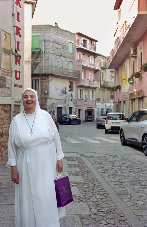 Nun in a white habit on a Sardinian village street Nun in a white habit on a Sardinian village street