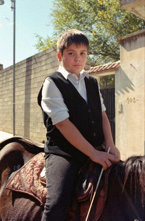 Boy on horseback in traditional dress at a Sardinian festival Boy on horseback in traditional dress at a Sardinian festival