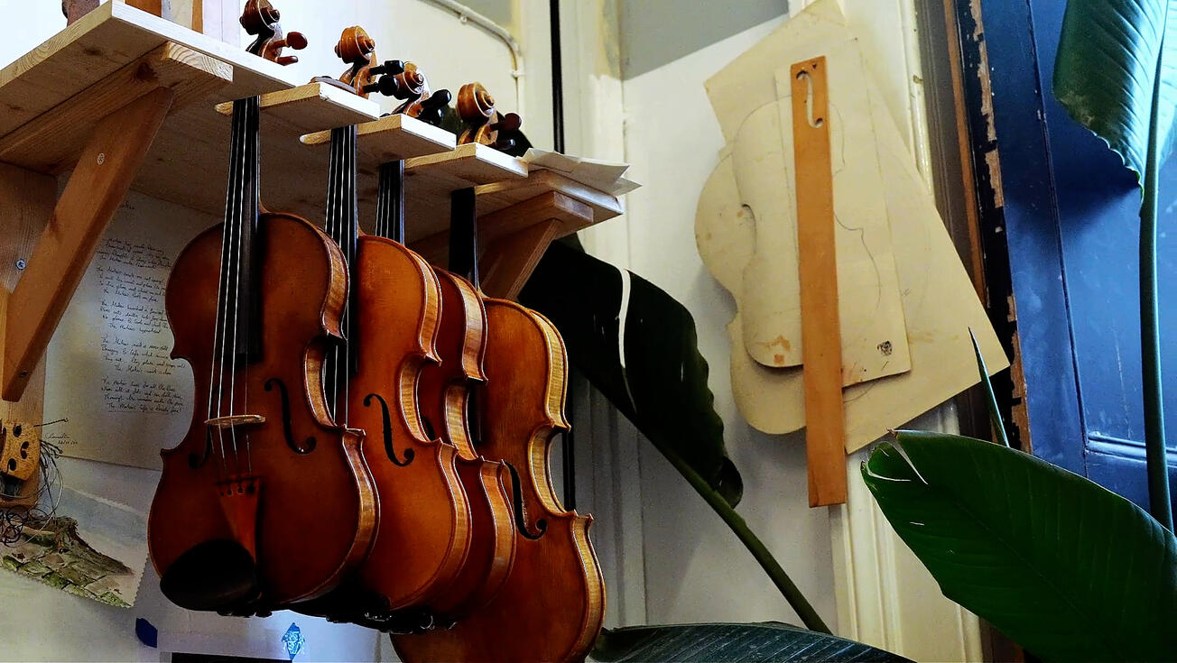 Handmade violins hanging in Jonathan Hill's workshop Handmade violins hanging in Jonathan Hill's workshop