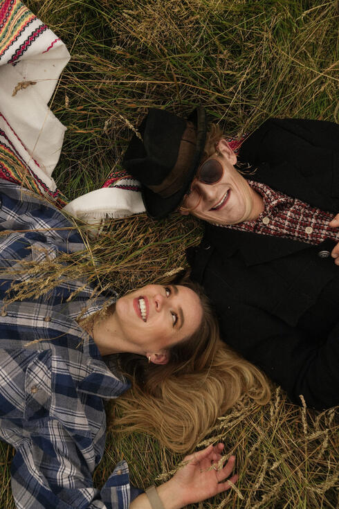 The Homburgs laughing together lying in a field The Homburgs laughing together lying in a field