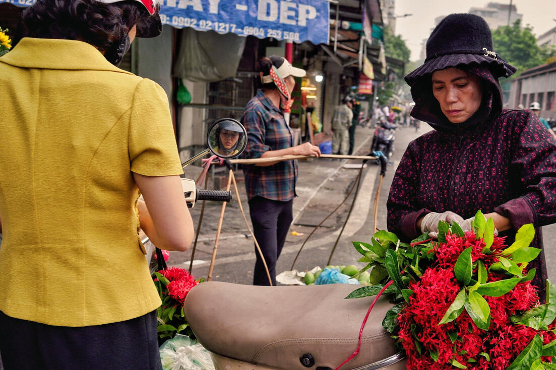 Flower vendors with laden bicycles on a Hanoi street Flower vendors with laden bicycles on a Hanoi street