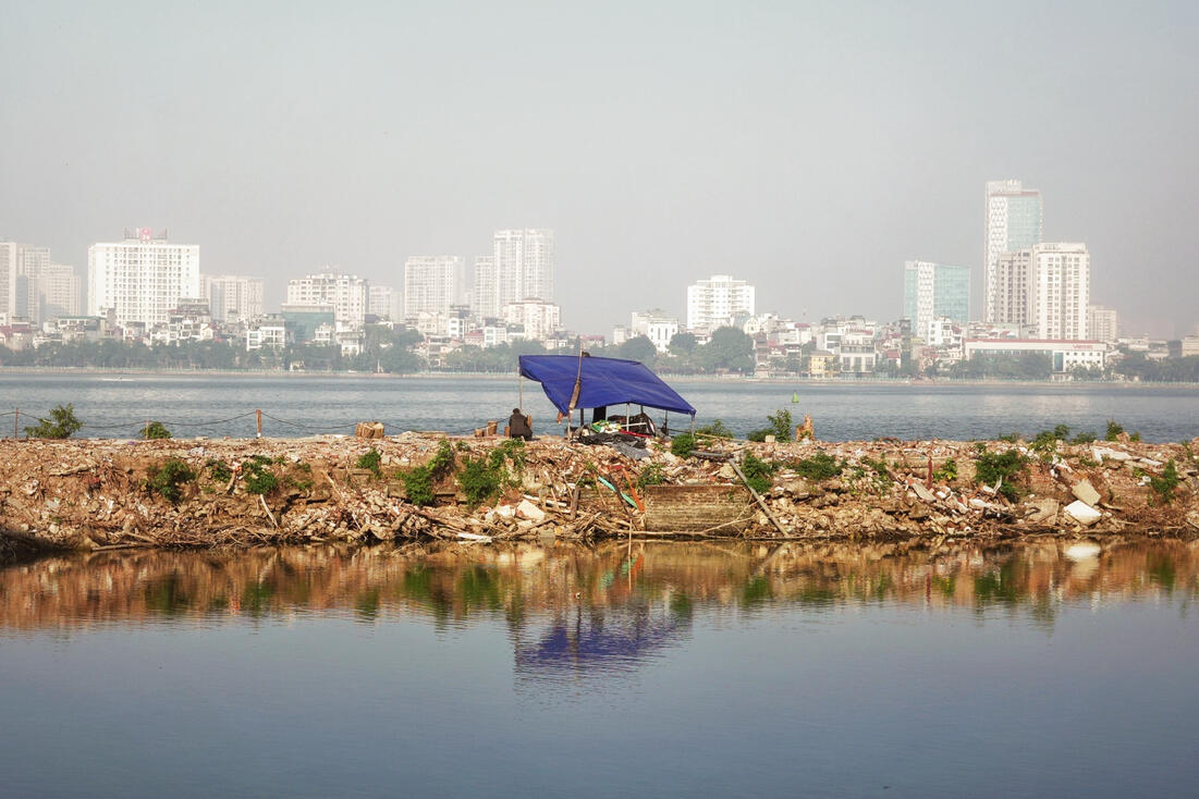 Fisherman's shelter on West Lake at dawn, Hanoi skyline behind Fisherman's shelter on West Lake at dawn, Hanoi skyline behind